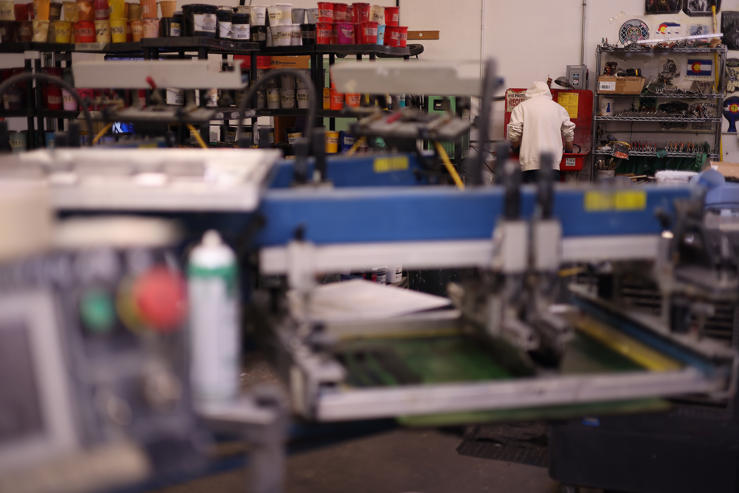 Screen printing station and ink shelves inside Rocky Mountain Apparel